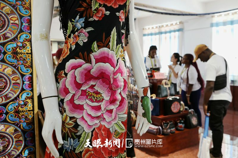 789560-2024年8月22日，在施秉县榜香郁苗绣企业展览厅，南昌航空大学研学团的外国留学生在了解苗绣作品。.jpg