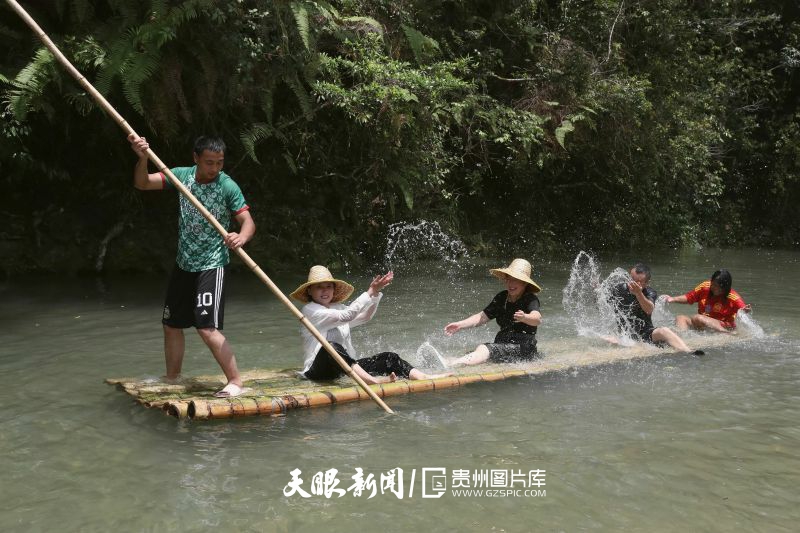 895535-2025年7月19日，在贵州省黔东南苗族侗族自治州榕江县水尾水族乡拉术村水上娱乐旅游点，人们在划竹排戏水纳凉。.jpg